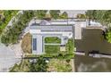 Overhead angle of large home showing expansive yard, dock and solar panels on roof at 9938 Alavista Dr, Gibsonton, FL 33534