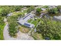 Aerial view of property featuring a large home with dock, solar panels and an expansive yard at 9938 Alavista Dr, Gibsonton, FL 33534