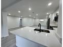 Open-concept kitchen featuring a white quartz countertop and breakfast bar overlooking the living area at 1005 S Empire St, Plant City, FL 33563