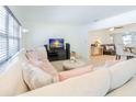 Bright living room featuring plush sectional sofa, modern furnishings, and ample natural light at 113 Maplewood Ave, Clearwater, FL 33765