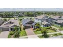 Aerial view of a single-Gathering home showcasing its well-maintained lawn, landscaping, and brick-paved driveway at 11315 Chilly Water Ct, Riverview, FL 33579