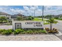 Entrance to Crestview Lakes, featuring well-maintained landscaping and an illuminated community sign at 11315 Chilly Water Ct, Riverview, FL 33579