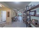 Inviting entryway featuring stylish flooring and decorative shelving; open to living area at 11327 Brighton Knoll Loop, Riverview, FL 33579