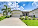 Charming single-story home with a well-manicured lawn and a spacious three car garage at 11619 Cambium Crown Dr, Riverview, FL 33569