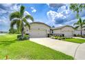 Charming single-story home featuring a manicured lawn, a triple car garage and stone accents at 11619 Cambium Crown Dr, Riverview, FL 33569