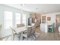 Sunlit dining area with modern chandelier, open to the kitchen, perfect for entertaining at 11717 74Th E Cir, Palmetto, FL 34221