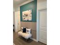 Stylish entryway features modern wall decor, accent pillows, and a cozy bench, creating a chic and inviting space at 11717 74Th E Cir, Palmetto, FL 34221