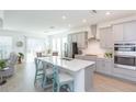 Bright, open kitchen featuring stainless steel appliances, quartz countertops, and an island with bar seating at 11717 74Th E Cir, Palmetto, FL 34221