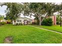 Inviting single-story home with a well-manicured lawn and mature shade trees at 121 28Th N Ave, St Petersburg, FL 33704