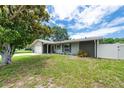 Well-maintained single-Gathering home boasting a green lawn, mature landscaping, and a serene, fenced backyard at 1461 S Hillcrest Ave, Clearwater, FL 33756