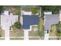 Top-down view of the home showcasing the dark roof, manicured lawn, and surrounding landscaping at 15012 Winterwind Dr, Tampa, FL 33624
