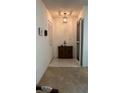 Entryway with carpeted seating area, tiled floor, coat closet, and wooden cabinet at 205 Strong Bow Ct, Sun City Center, FL 33573