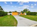 Single-story home with a well-manicured lawn and extended driveway at 2818 Lorraine St, Tampa, FL 33614