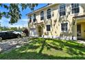 Lovely two-story townhome featuring a one-car garage, lush lawn, and a spacious driveway at 310 S Willow Ave # A, Tampa, FL 33606