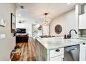 Open-concept kitchen with marble counters, a dining area, and modern pendant lighting at 310 S Willow Ave # A, Tampa, FL 33606