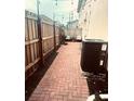 Private brick patio with a wood fence and outdoor seating offering a cozy retreat at 310 S Willow Ave # A, Tampa, FL 33606