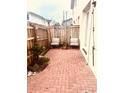 Charming brick patio featuring a cozy seating area with a wood fence at 310 S Willow Ave # A, Tampa, FL 33606