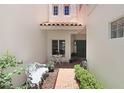 Charming courtyard entrance with a table, seating, and red brick pathway at 3145 Lake Ellen Dr # 3145, Tampa, FL 33618
