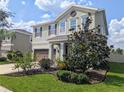 Well-maintained two-story home featuring a manicured lawn and decorative landscaping around the property at 32599 Natural Bridge Rd, Wesley Chapel, FL 33543