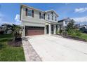Beautiful two-story home with a well-manicured lawn, private driveway, and attached two-car garage at 32599 Natural Bridge Rd, Wesley Chapel, FL 33543
