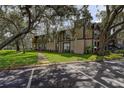 Exterior view of a multi-story condo building with ample parking and green spaces at 4012 Tumble Wood Trl # 104, Tampa, FL 33613