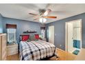 Cozy main bedroom with hardwood floors and a ceiling fan at 4085 105Th N Ave, Clearwater, FL 33762