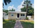 Attractive single Gathering home with a brick walkway, freshly painted facade, and neat landscaping at 4111 W Grace St, Tampa, FL 33607