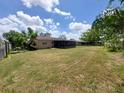 Spacious backyard with a screened lanai, surrounded by lush greenery, offering privacy and tranquility at 432 Flamingo Dr, Apollo Beach, FL 33572