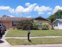 Charming single-story home with a well-maintained lawn and mature landscaping on a sunny day at 432 Flamingo Dr, Apollo Beach, FL 33572