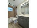 Cozy bathroom featuring a tiled shower-tub combo, neutral finishes, and modern vanity at 5025 Tammy Ln, Holiday, FL 34690