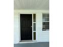Close-up of a black front door with decorative glass and house number 5025 at 5025 Tammy Ln, Holiday, FL 34690