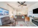 Open-concept living room with hardwood floors and ceiling fan leading to dining room at 5065 Royal Palms Way # 303, New Port Richey, FL 34652