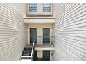 Exterior view of condo units with doors and stairs and beige siding at 5103 Puritan Cir # 5103, Tampa, FL 33617