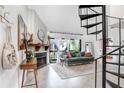 Bright living room features spiral staircase, fireplace, console table, large windows and a comfortable looking couch at 5103 Puritan Cir # 5103, Tampa, FL 33617