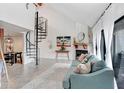 Bright living room with spiral staircase, stylish furniture, fireplace, and view to dining area at 5103 Puritan Cir # 5103, Tampa, FL 33617