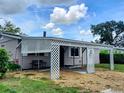 Home exterior featuring an extended carport with decorative lattice, providing sheltered access and curb appeal at 5221 82Nd N Ave, Pinellas Park, FL 33781