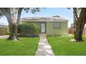 Cozy single-story home with a green exterior and well-manicured front yard at 5725 18Th S Ave, Gulfport, FL 33707