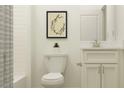 Bright, clean bathroom featuring a shower/tub, toilet, vanity with a white cabinet, and quartz countertop at 6611 Active Run, New Port Richey, FL 34653