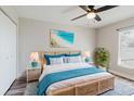 Cozy main bedroom with a stylish wicker bed frame, bright decor, and a ceiling fan at 706 E Gate Dr, Safety Harbor, FL 34695
