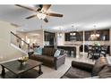 Open-concept living space featuring a modern kitchen with dark cabinets and a large center island at 8636 Prairie Creek Dr, New Port Richey, FL 34655