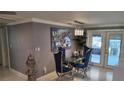 Dining area with glass table, blue chairs, light fixture and an elegant decorative painting on the wall at 9161 56 Th, Pinellas Park, FL 33782