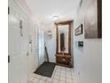 Inviting foyer features tiled flooring and decorative mirror at 9205 Jakes Path, Largo, FL 33771