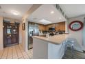 Well-lit kitchen features stainless steel appliances and breakfast bar at 9205 Jakes Path, Largo, FL 33771