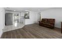 Open-concept living room with modern floors and lots of natural light at 10730 Premier Ave, Port Richey, FL 34668
