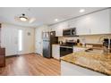 Bright kitchen features white cabinetry, granite countertops, and stainless steel appliances at 12000 Gulf Blvd # 403-S, Treasure Island, FL 33706