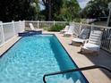 Relaxing pool area with lounge chairs and a built-in spa for enjoying the outdoors at 12458 1St W St, Treasure Island, FL 33706
