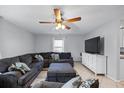 Comfortable living room with a large sectional sofa and a ceiling fan at 12660 118Th St, Largo, FL 33778