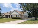 Beautiful single-story home with well-manicured lawn and long driveway, showcasing classic curb appeal at 13122 Done Groven Dr, Dover, FL 33527