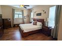 Comfortable bedroom with hardwood floors, natural light, and cozy decor at 13122 Done Groven Dr, Dover, FL 33527