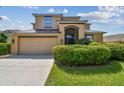 A two-story home with a well manicured front yard featuring beautiful shrubbery at 1314 Oak Pond St, Ruskin, FL 33570